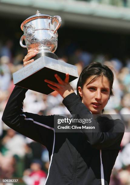 Anastasia Myskina of Russia celebrates with the trophy after winning her womens final match against Elena Dementieva of Russia during Day Thirteen of...