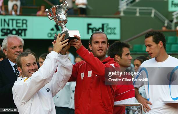 Xavier Malisse and Olivier Rochus of Belgium celebrate with the trophy after winning their mens doubles final match against Michael Llodra and...