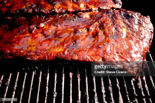 beef ribs cooking on charcoal grill - rib stock pictures, royalty-free photos & images