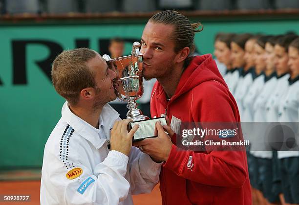 Xavier Malisse and Olivier Rochus of Belgium kiss the trophy after winning their mens doubles final match against Michael Llodra and Fabrice Santoro...