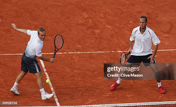 Xavier Malisse and Olivier Rochus of Belgium return serve in their mens doubles final match against Michael Llodra and Fabrice Santoro of France,...