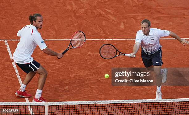 Xavier Malisse and Olivier Rochus of Belgium return serve in their mens doubles final match against Michael Llodra and Fabrice Santoro of France...