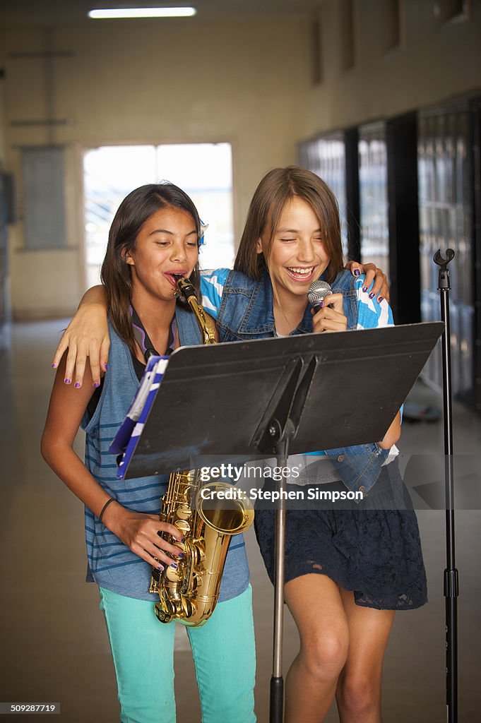 Teen girls practicing their music in hallway