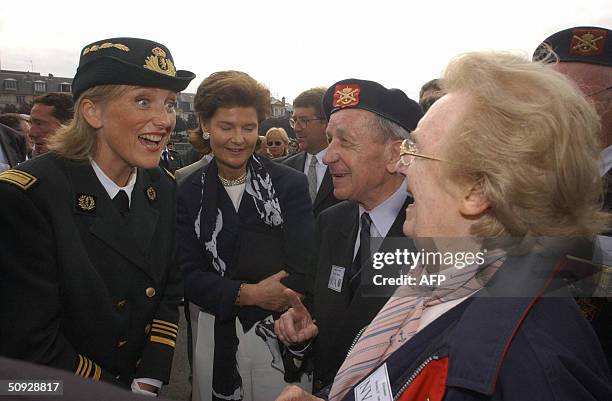 Princess Astrid of Belgium and Princess Margaretha of Luxembourg chat with Belgium WWII veterans, 05 June 2004 in Deauville, during a ceremony...