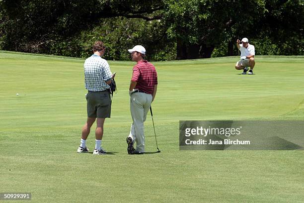 Greg Kinnear chats with a partner during the Jiffy Lube Dennis Quaid Charity Classic Golf Tournament on June 5, 2004 at the Avery Ranch Golf Club in...