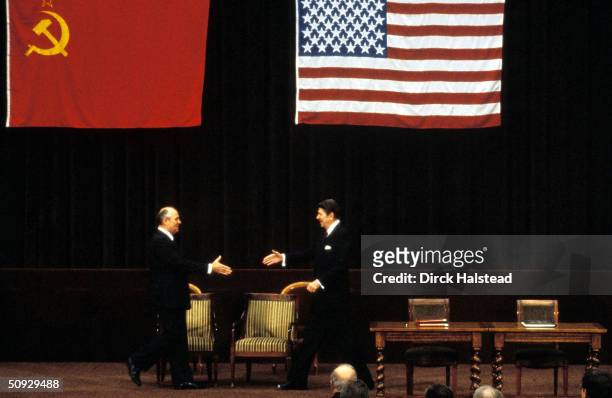 Soviet Premier Mikhail Gorbachev and U.S. President Ronald Reagan stride across the stage towards each other at their first summit meeting November...