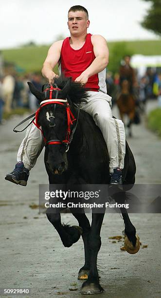 Gypsy rides his horse at speed for the benefit of buyers along the 'mad mile' at Appleby Horse Fair June 5, 2004 in Appleby, England. Appleby Horse...