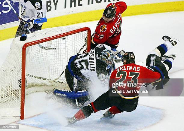 Goaltender Nikolai Khabibulin of the Tampa Bay Lightning stops a puck shot by Martin Gelinas of the Calgary Flames during the third period in game...