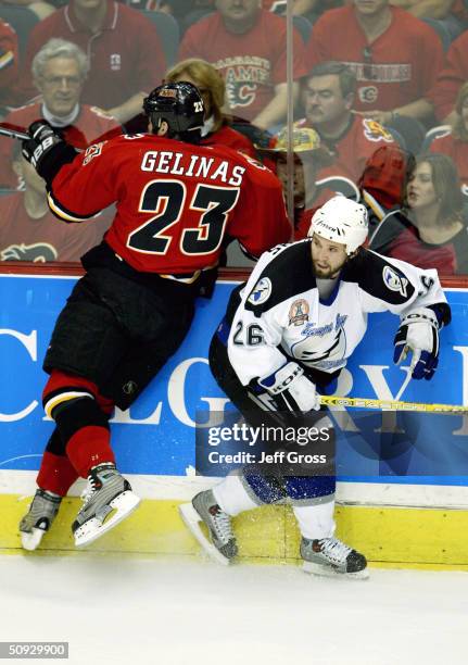 Martin Gelinas of the Calgary Flames misses the check on Martin St. Louis of the Tampa Bay Lightning in game six of the NHL Stanley Cup Finals on...