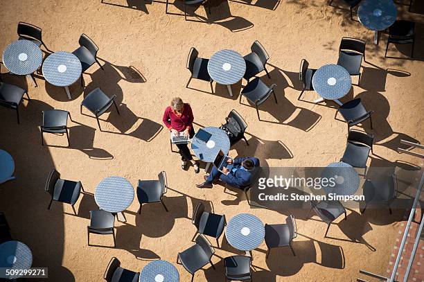 overhead view, cafe tables and business colleagues - cafe table chair outside ストックフォトと画像