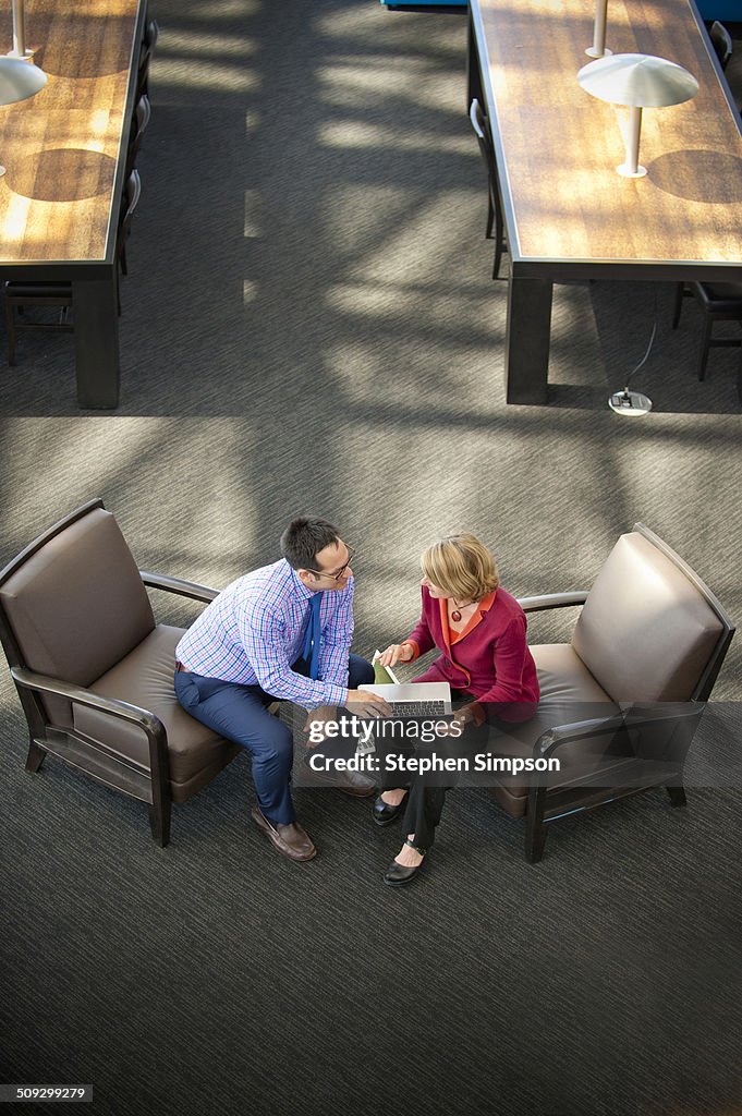 Overhead view of executives with laptops