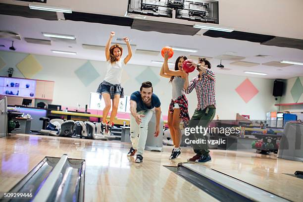 cheerful friends bowling together - bowling fun stockfoto's en -beelden