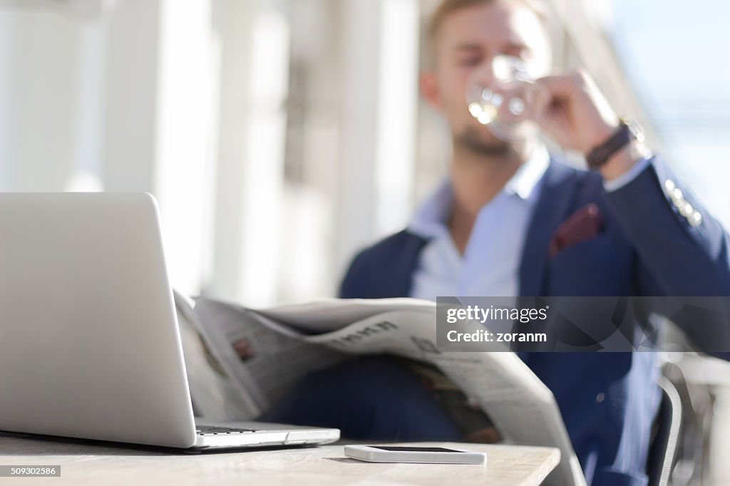 Businessman enjoying white wine