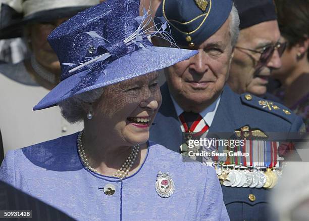 Queen Elizabeth II greets Canadian D-Day veterans June 6, 2004 at commemoration ceremonies at Juno Beach in Normandy, France. Leaders of former...