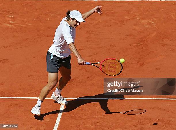 Gaston Gaudio of Argentina serves in his men's final match against Guillermo Coria of Argentina during Day Fourteen of the 2004 French Open Tennis...