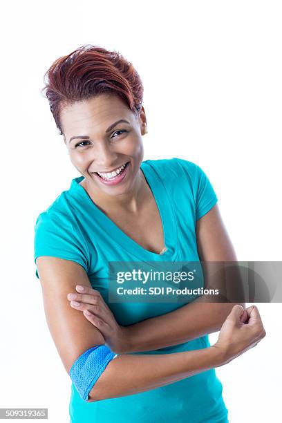 happy african american woman with bandage after donating blood - african american band aids stock pictures, royalty-free photos & images