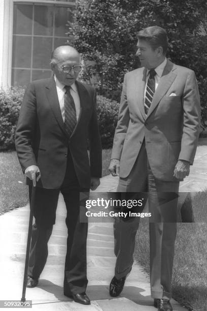 President Ronald Reagan and Israeli Prime Minister Menahem Begin walk in the White House gardens June 21, 1982 in Washington, DC. Reagan, the...