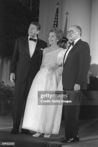 President Ronald Reagan poses with his wife Nancy Reagan and Israeli Prime Minister Menahem Begin during an gala dinner at the White House September...