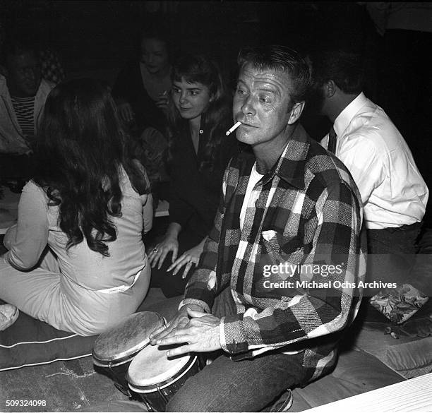 Actor Gene Nelson plays the bongos at Pandora's Coffee House on Sunset Boulevard in Los Angeles,California. Gene Nelson"n