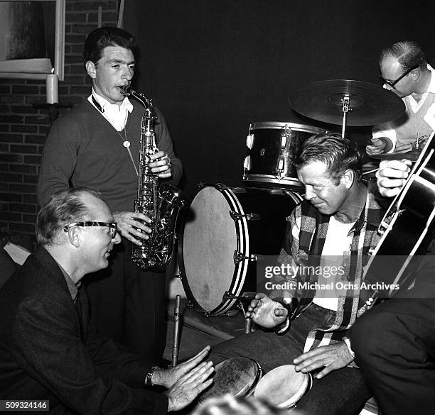 Actor Gene Nelson plays the bongos with jazz players at Pandora's Coffee House on Sunset Boulevard in Los Angeles,California. Gene Nelson