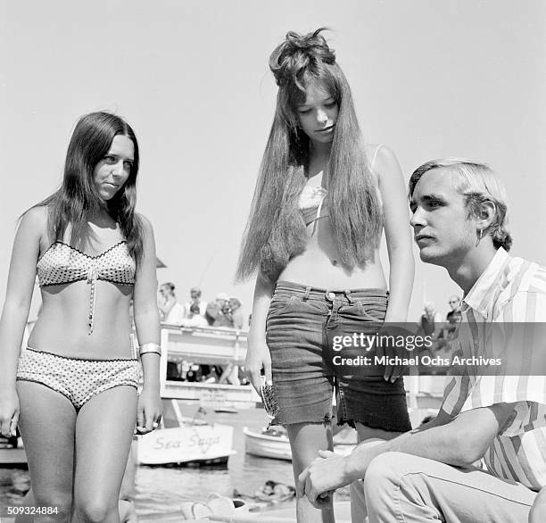 California beach girl Cha Cha Poster 15, with Steve Foote 18, wearing an earring, a new fad among California beach boys on Balboa Island in Newport...