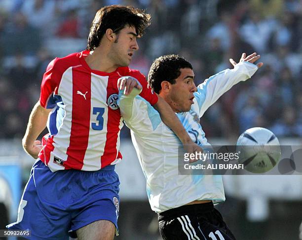 Argentine Carlos Tevez , battles for the ball with Paraguayan Julio Caceres, during a football match at the Monumental stadium in Buenos Aires,...