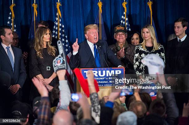 Republican presidential candidate Donald Trump, surrounded by family and friends, shouts as he celebrates his victory at a New Hampshire primary...