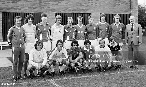 World Cup winning manager Sir Alf Ramsey joins his Birmingham City players for an unusal team photograph, with the group wearing a collection of...