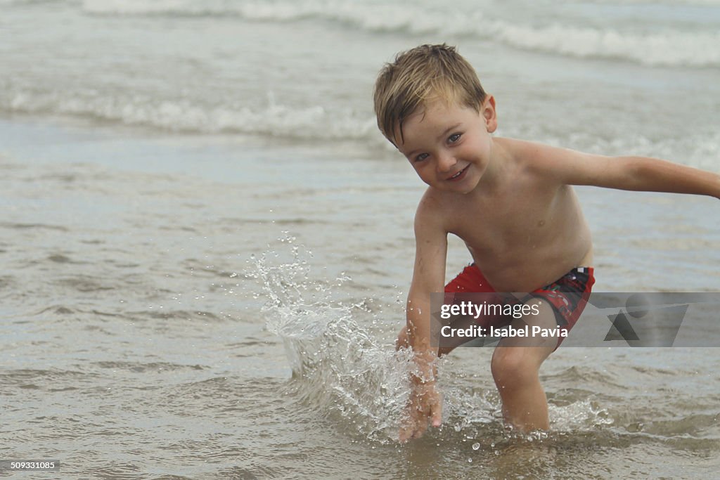 Boy playing with waves