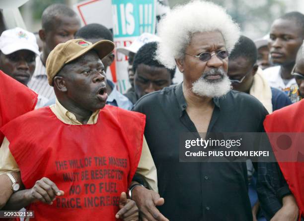 President of the Nigerian Labour Congress Adams Oshimhole hold hands with Wole SoyinkaNigerian Nobel laureate Wole Soyinka during a demonstration...