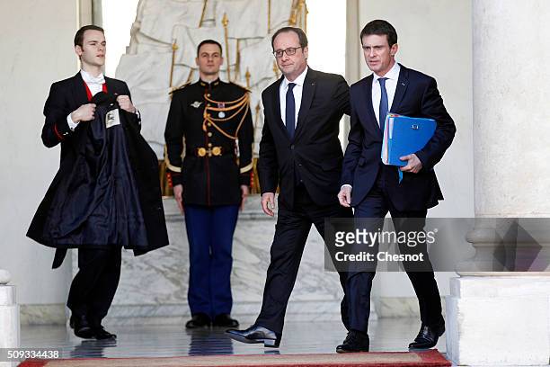 French President Francois Hollande talks with French Prime Minister Manuel Valls after the weekly cabinet meeting at the Elysee Palace on February...