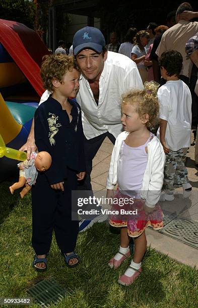 Actor Luke Perry and kids Jack and Sophie attend an afterparty for the premiere of "Garfield - The Movie" at the Twentieth Century Fox studio lot on...