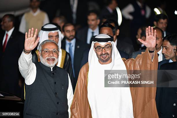Indian Prime Minister Narendra Modi and Crown Prince of Abu Dhabi Sheikh Mohammed Bin Zayed Al Nahyan wave to the crowd after the prince arrived at...