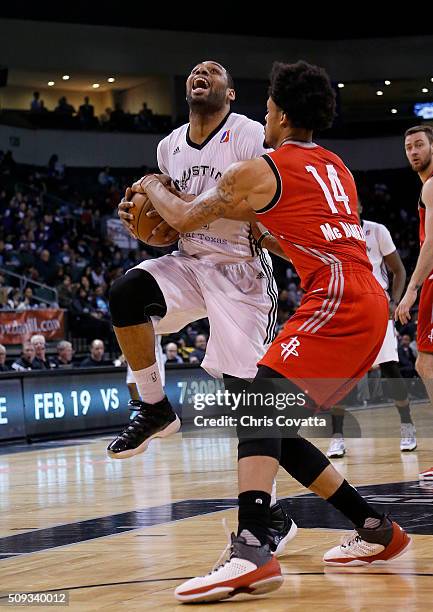 Demetri McCamey of the Austin Spurs is fouled while shooting by KJ McDaniels of Rio Grande Valley Vipers at the Cedar Park Center on February 9, 2016...