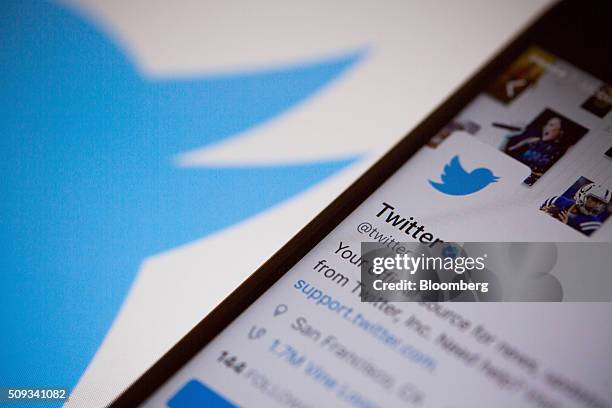 The Twitter Inc. Logo is seen behind an Apple Inc. IPhone 6s displaying the company's mobile application in this arranged photograph taken in New...