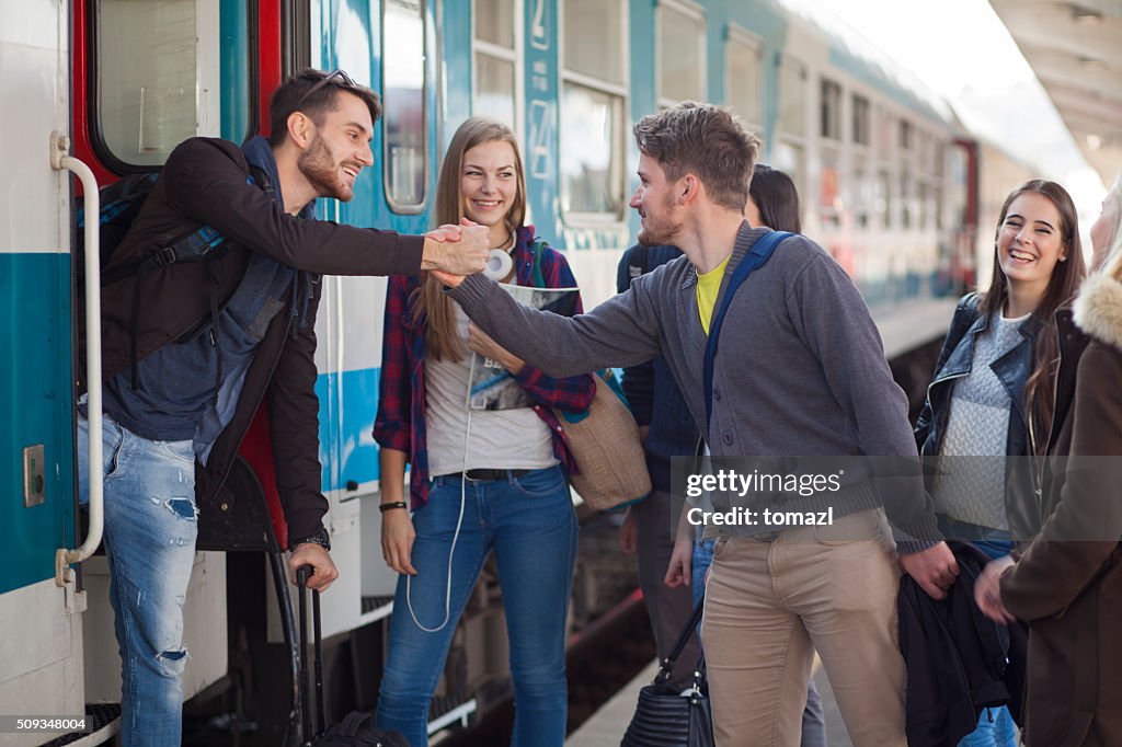 Young people saying goodby on a train station