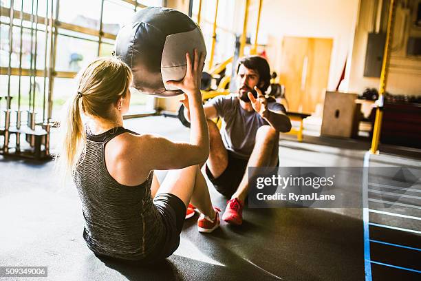 ab crunches with medicine ball - medicine ball stock pictures, royalty-free photos & images