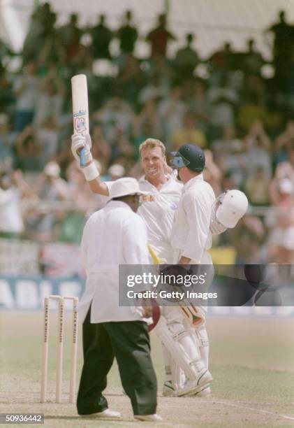 Alec Stewart of England acknowledges his century during the fourth test match between the West Indies and England on April 8-13, 1994 at the...