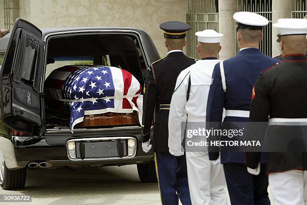 Joint service US military honor guard prepares to remove the casket bearing the remains of former US president Ronald Reagan at the Ronald Reagan...