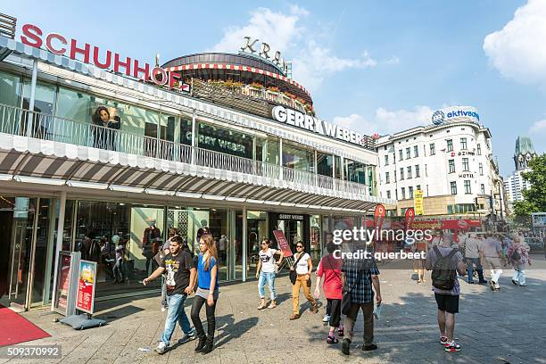 people passing the shopping mall kranzler eck in berlin - kurfürstendamm stock pictures, royalty-free photos & images