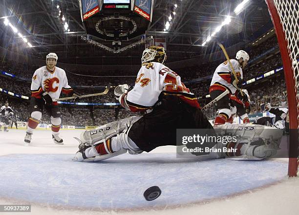 Miikka Kiprusoff of the Calgary Flames allows Ruslan Fedotenko of the Tampa Bay Lightning to score his second goal of the game during the second...