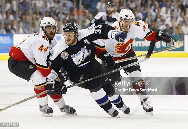 Rhett Warrener and Ville Nieminen of the Calgary Flames defend Fredrik Modin of the Tampa Bay Lightning in game seven of the NHL Stanley Cup Finals...