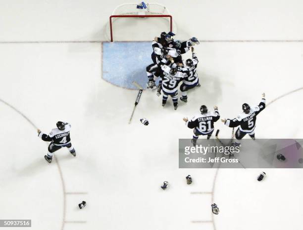 The Tampa Bay Lightning celebrate with teammate goaltender Nikolai Khabibulin after defeating the Calgary Flames 2-1 in game seven of the NHL Stanley...