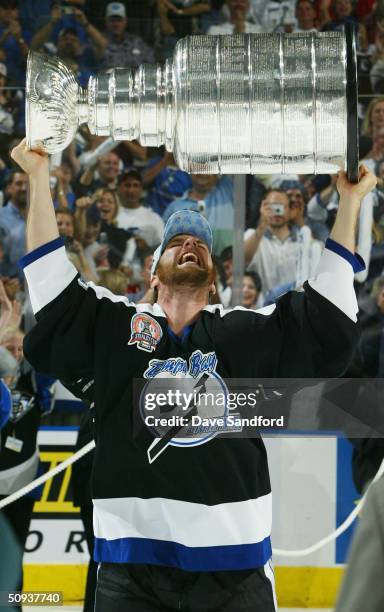 Andre Roy of the Tampa Bay Lightning celebrates with the Stanley Cup trophy after defeating the Calgary Flames 2-1 to win game seven of the NHL...