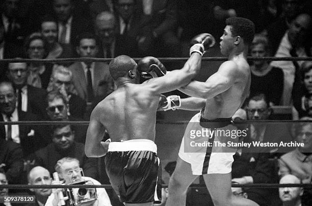 Cassius Clay in action, throwing a left, and avoiding a right from Doug Jones during their heavyweight bout at Madison Square Garden, New York, New...