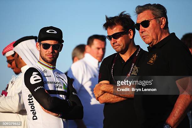 Mark Cavendish of Great Britain and Dimension Data stands with Sport Technical Director John Lelangue and Eddy Merckx at the podium for stage three...