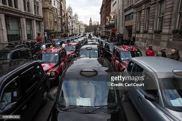 Black Cab drivers block Whitehall as they take part in a protest against Uber on February 10, 2016 in London, England. Drivers are claiming that Uber...