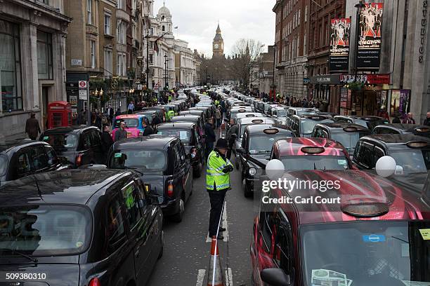 Black Cab drivers block Whitehall as they take part in a protest against Uber on February 10, 2016 in London, England. Drivers are claiming that Uber...