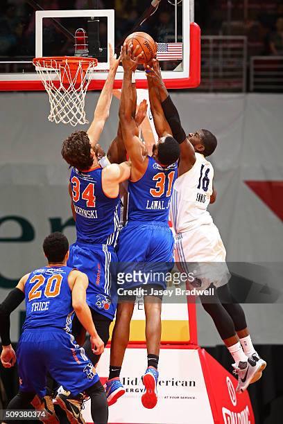 James Ennis of the Iowa Energy goes up for a rebound against Jordan Bachynski and Gani Lawal of the Westchester Knicks in an NBA D-League game on...