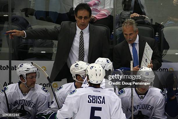 Willie Desjardins of the Vancouver Canucks directs the team along with assistant coach Doug Lidster during a time out against the Colorado Avalanche...